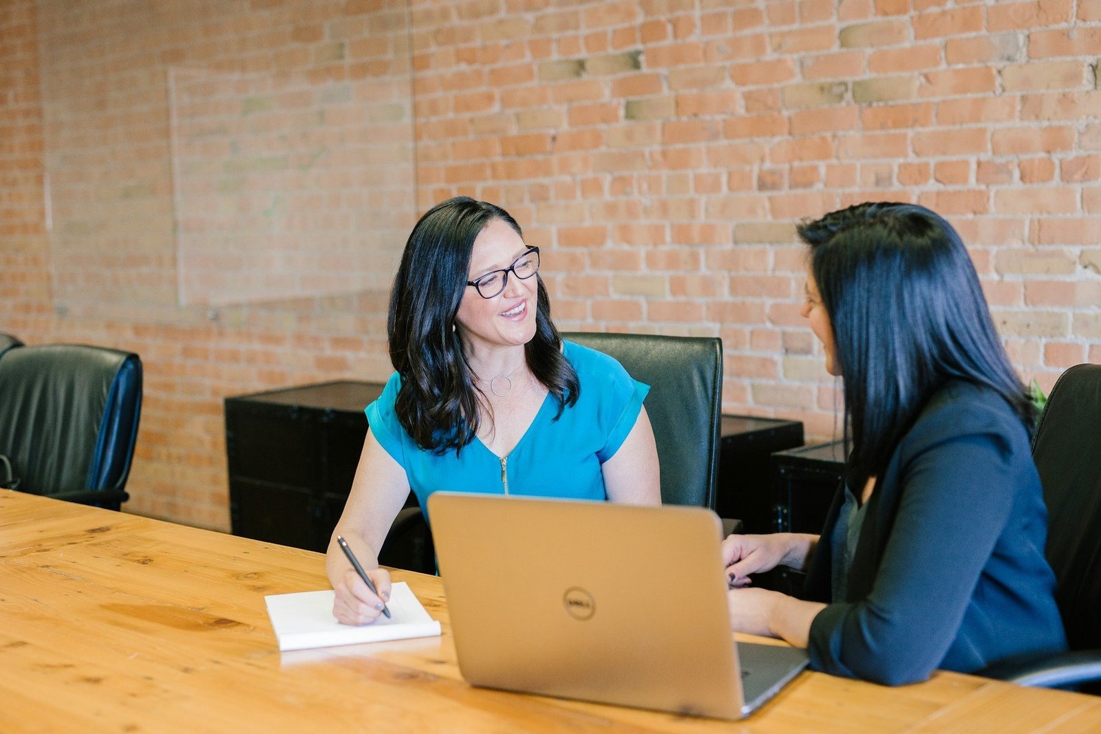 People having a focused conversation around an office table